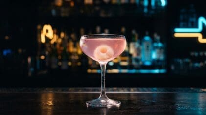Lychee Martini in a coupe with a single peeled lychee garnish.