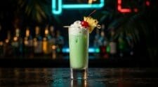 Scooby Snack shot in a tall shot glass with creamy pale green colour from Midori, coconut rum and pineapple